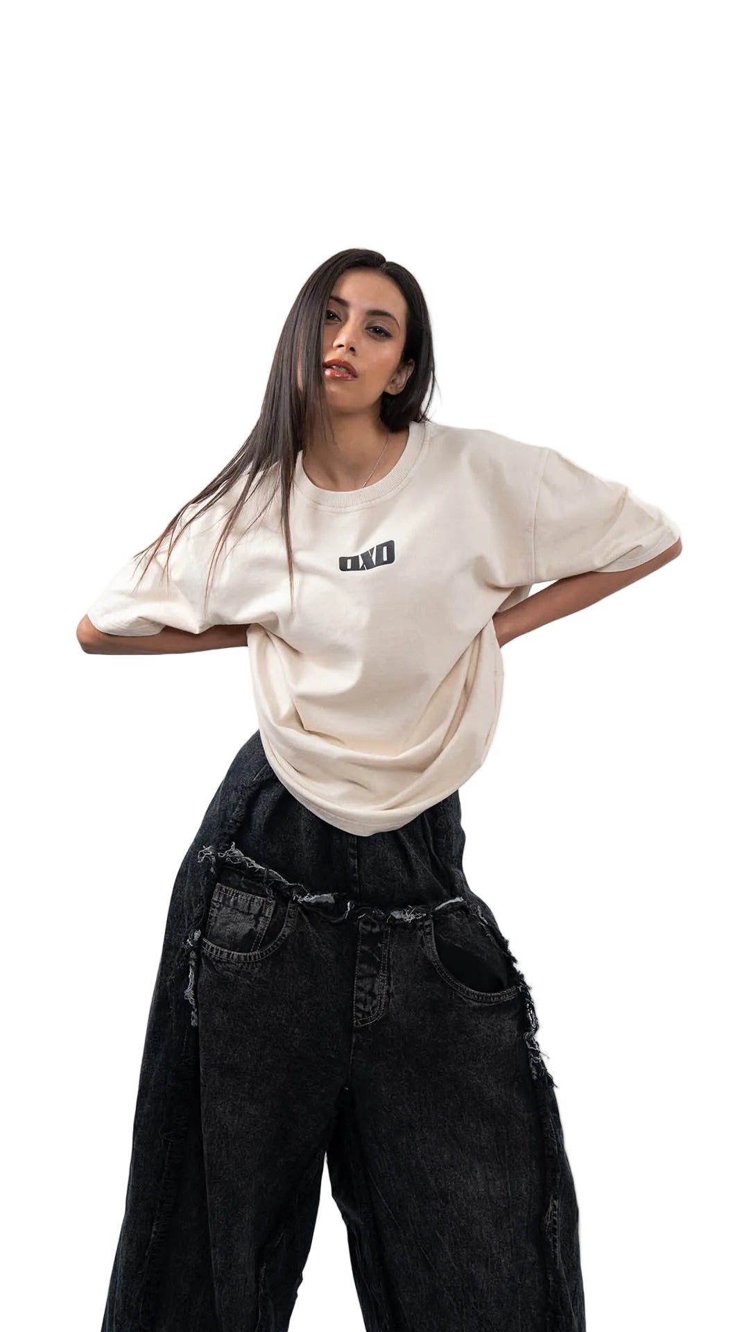 Woman wearing a white oversized t-shirt with dxdstudios logo and black pants on a white background