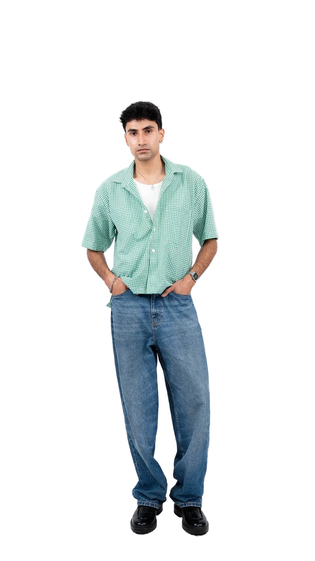 Man wearing a green checkered shirt and blue jeans on a white background