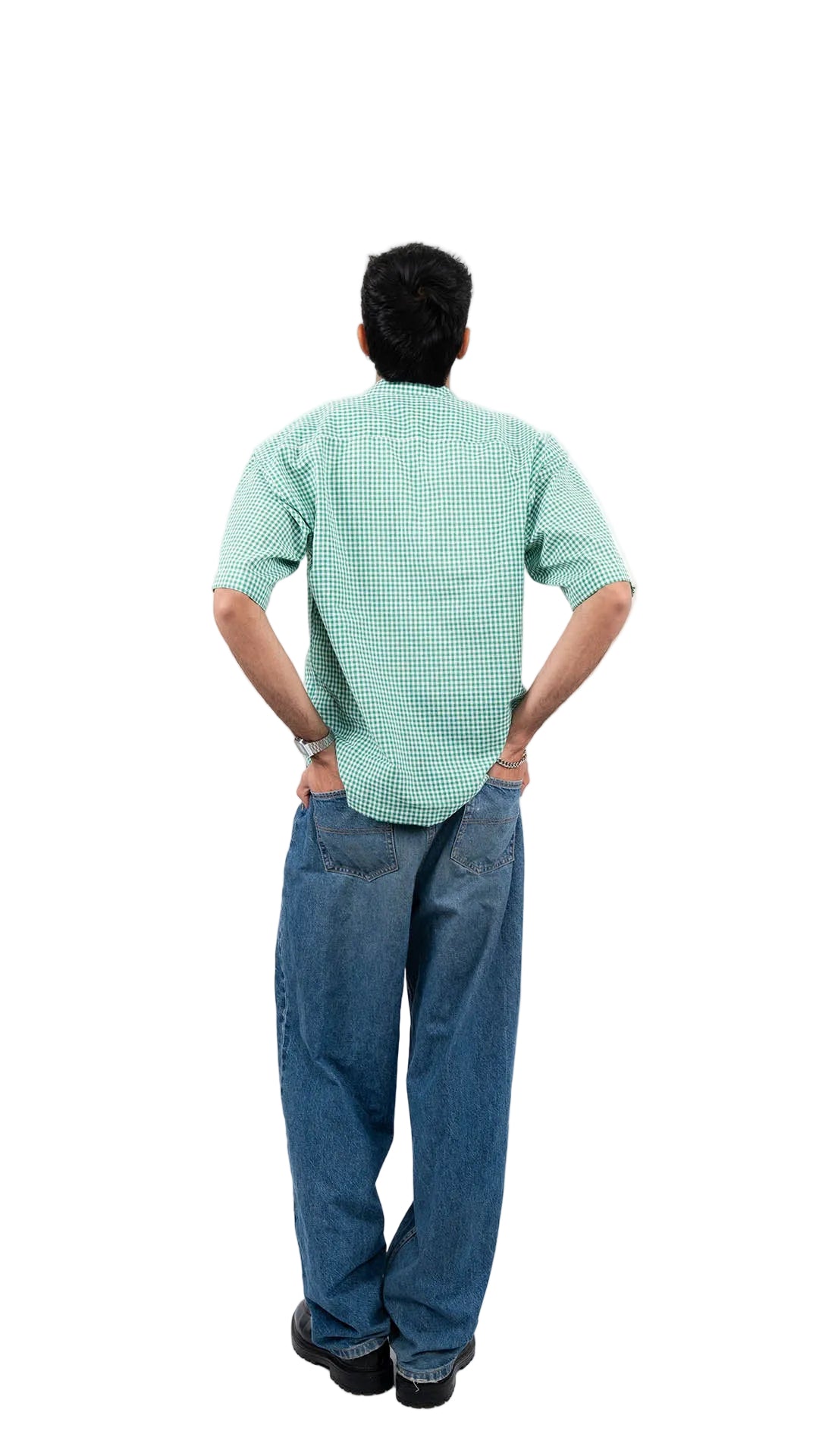 Man wearing a green checkered shirt and blue jeans on a white background