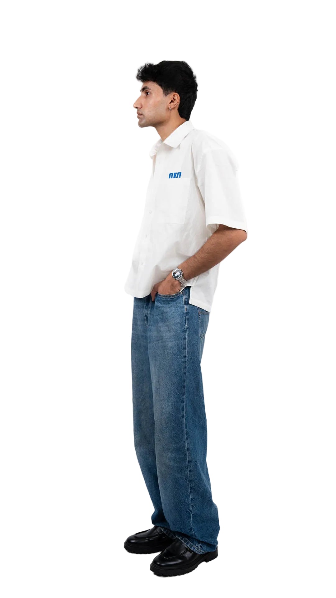 Person wearing a white shirt with a dxdstudios logo and blue jeans on a white background
