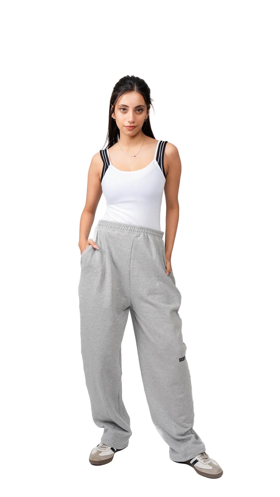 Woman wearing a white tank top and gray sweatpants on a white background