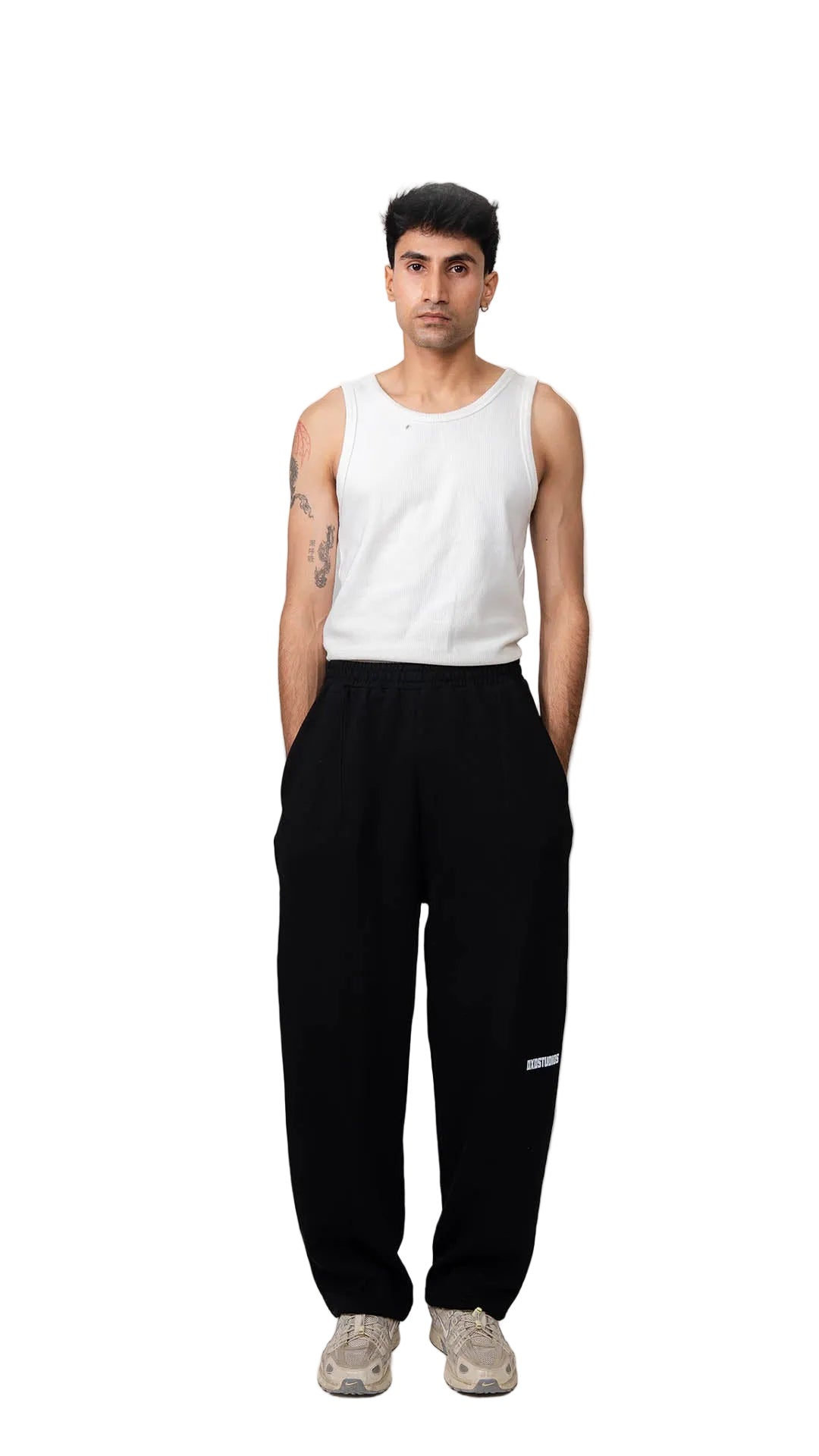 Person wearing a white tank top and black pants on a white background