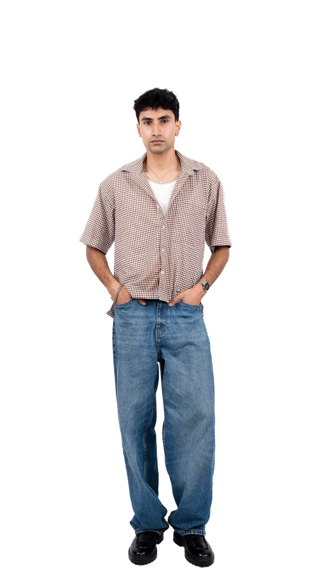Man wearing a checkered shirt, white t-shirt, blue jeans, and black shoes on a white background
