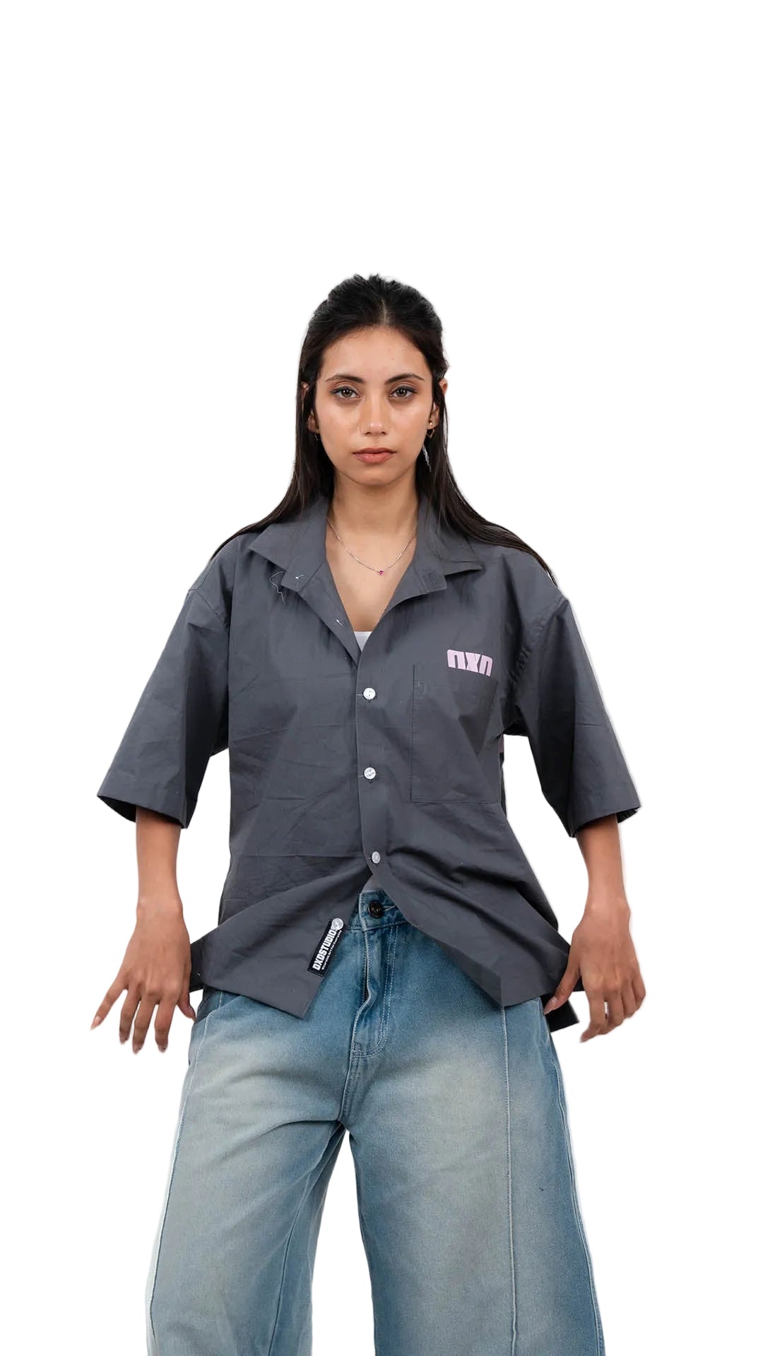 Person wearing a gray shirt and denim shorts on a white background